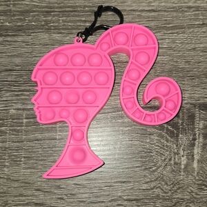 Barbie Push Pop Silicone Bubble Fidget Toy. The keychain is approximately 4.5"